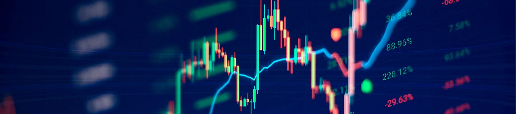 Uma tela de monitor exibe um gráfico em cores vermelhas, verdes e azuis, representando dados voláteis do mercado financeiro ou de negócios. O gráfico simboliza a complexidade e os desafios estatísticos relacionados à taxa de sobrevivência das empresas no Brasil.